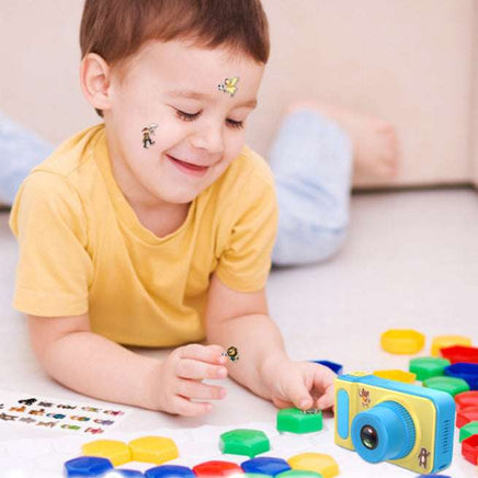 Child playing with colorful camera