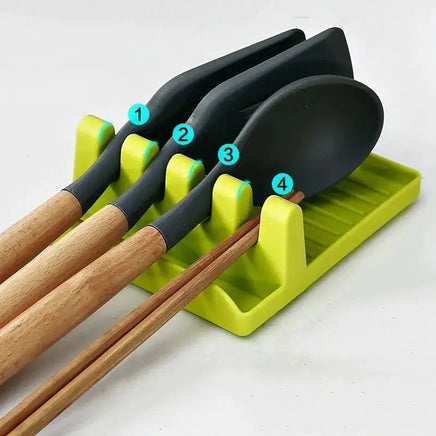 Green spatula drain rack gadget holding spatulas and chopsticks, designed for organized kitchen utensil storage.