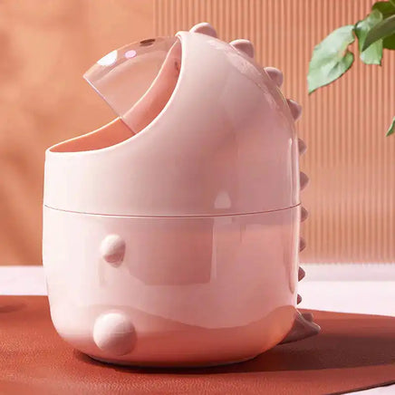 Side view of pink dinosaur desktop trash can showing open lid and tail details, a cute and functional desk accessory.