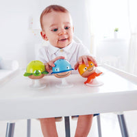 Child playing with colorful sea animal rattles