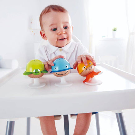 Child playing with colorful sea animal rattles