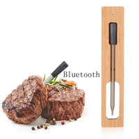 Wireless Kitchen Thermometer inserted in grilled steak, showcasing Bluetooth connectivity and bamboo charging dock for accurate meat cooking.