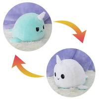 Mint green and white narwhal double-sided plush toy with reversible sad and happy expressions. Adorable and soft from Shop Name.