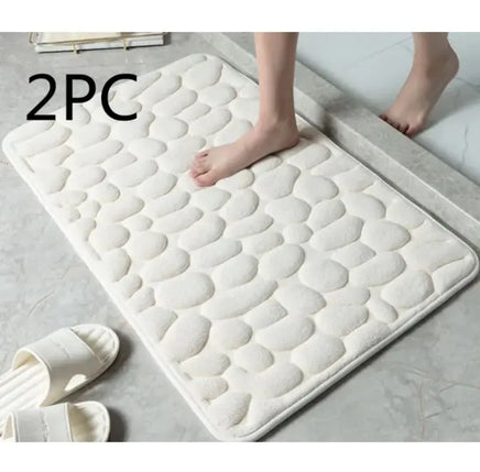 White super absorbent shower room floor mat with a pebble-like texture, sold as a 2-piece set, placed near a shower area.