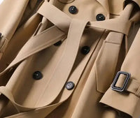 Classic beige trench coat with black buttons, a belted waist, and detailed stitching, perfect for timeless and sophisticated outerwear.