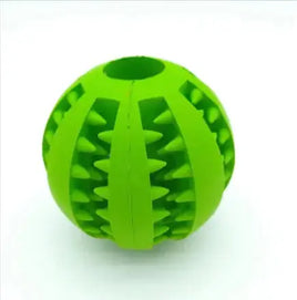 Green interactive rubber slow feeder dog ball with textured grooves for dispensing treats, ideal for chewing and play.