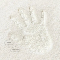 Impression of a handprint on the fluffy surface of the 60cm Rainbow Art Cartoon Carpet, emphasizing its super soft and plush texture.