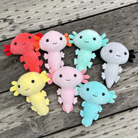 Set of colorful anime axolotl plush toys in various shades, displayed on a wooden surface, perfect for collectors.