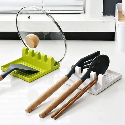 Green and white spatula drain rack gadgets holding spatulas, chopsticks, and a pot lid for organized kitchen use.