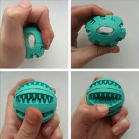 Demonstration of a turquoise interactive rubber slow feeder dog ball being squeezed to show its flexibility and treat slots.