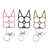 Three Portable Cute Cat Multifunction Outdoor Gadgets Keychains in pink, black, and gold displayed upright with attached key rings.