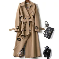 Classic beige trench coat with double-breasted design, belted waist, and plaid lining, paired with black heels and a quilted handbag.