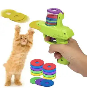 Hand-held Interactive Cat Toy Launcher shooting foam discs with excited cat jumping. Great for indoor fun and active pet play.