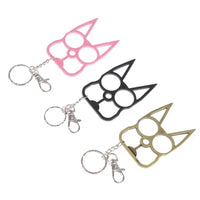 Portable Cute Cat Multifunction Outdoor Gadgets Keychains in pink, black, and gold laid flat with attached key rings and clips.