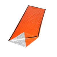 Bright orange emergency sleeping bag with reflective silver interior, designed for thermal insulation and survival situations.