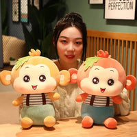 Two Sitting Monkey Plush Toys in orange and yellow displayed on a table, highlighting their charming details.