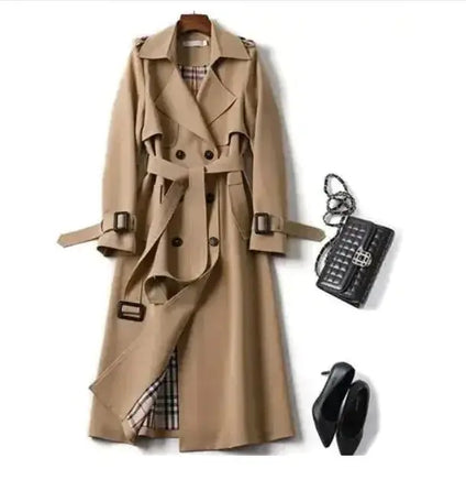 Classic beige trench coat with a belted waist, double-breasted design, and plaid lining, styled with a black handbag and heels.