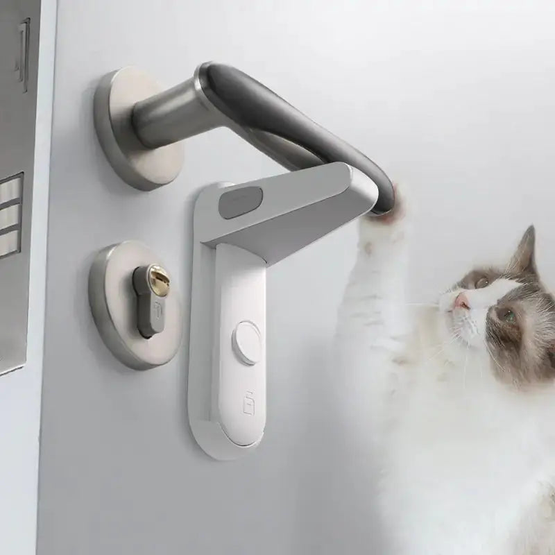 Safety Door Lever Lock installed on a modern door handle, preventing access while a curious cat reaches toward the handle.