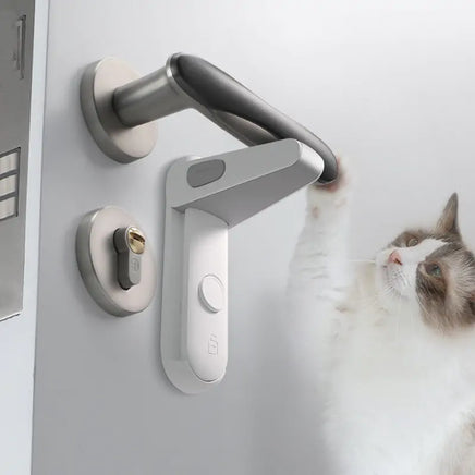 Safety Door Lever Lock installed on a modern door handle, preventing access while a curious cat reaches toward the handle.