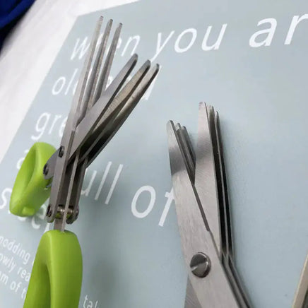 Detailed view of multifunctional green onion scissors showing sharp stainless steel blades and ergonomic green handles.