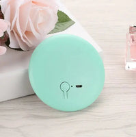 Pastel green Pocket LED Makeup Mirror with a compact design, perfect for travel and on-the-go makeup needs.