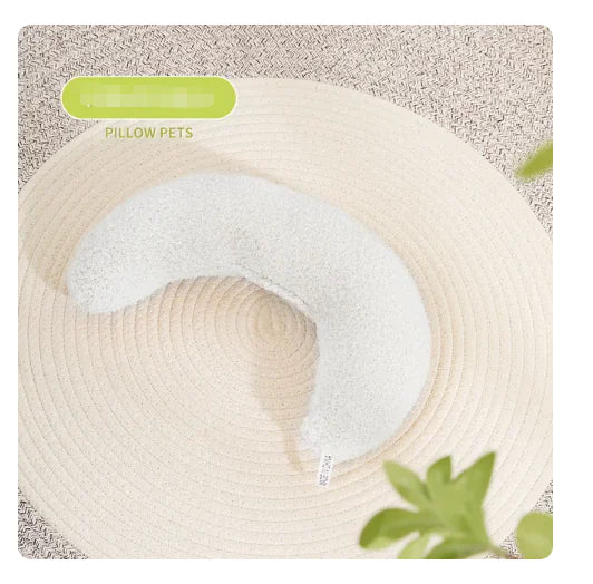 U-shaped pet pillow on beige textured surface