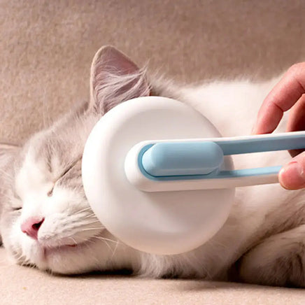 Cat being groomed with a blue Automatic Hair Remover & Massage Comb, showcasing its soothing massage functionality.