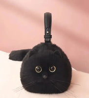 Black handmade plush cat bag with golden eyes and a black strap, designed as a quirky and stylish messenger bag for everyday use.