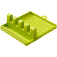 Green spatula drain rack gadget with four slots and a drip tray, perfect for kitchen utensil storage.