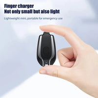 Mini 1500mAh emergency power bank held between fingers, emphasizing its lightweight and compact design for portability.