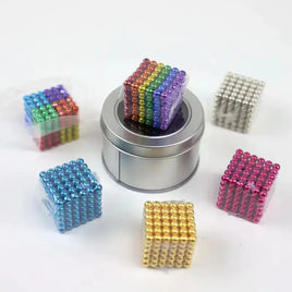 Multiple cubes of magnetic metal balls in various colors displayed with a silver storage tin, showcasing creative stacking options.
