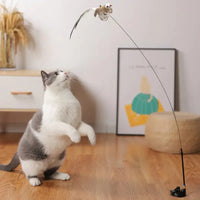 Cat standing on hind legs reaching for a bird-shaped toy on a flexible rod, promoting active play for cats.