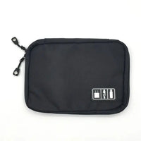 Black portable gadget organizer bag with a sleek design, dual zippers, and a label for electronic accessory storage.