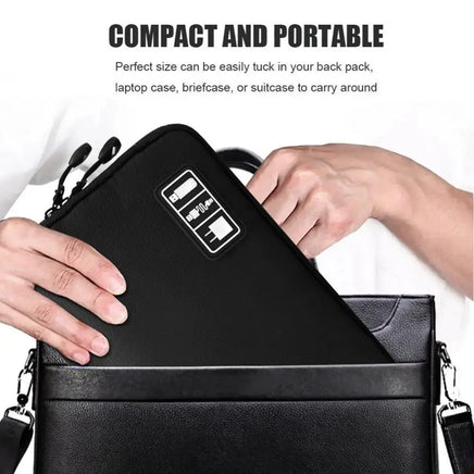 Compact black gadget organizer bag being placed into a briefcase, emphasizing portability and convenience.