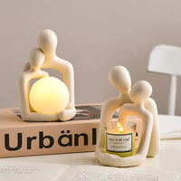 Set of Nordic couple statues featuring a glowing orb and candle holder, perfect for modern home decor.