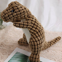 Brown dinosaur plush dog toy with a textured surface, perfect for dogs to chew and cuddle.