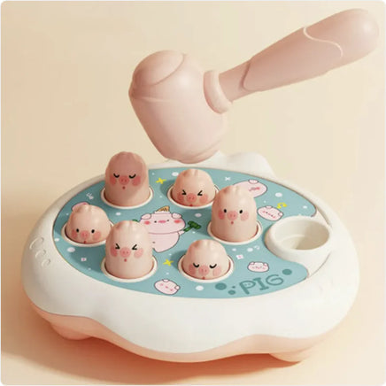 Groundhog Educational Toy with a pink pig theme, showcasing a hammer and pop-up pig figures on a durable plastic base.