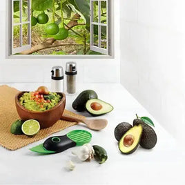 Essential Kitchen Five Gadget Bundle displayed on a countertop with avocados, lime, and guacamole in a bowl, set against a window view of lime trees.