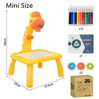 Mini-sized Kids Art Table Set with a yellow giraffe projector, markers, stencil discs, an art booklet, and packaging for creative play.