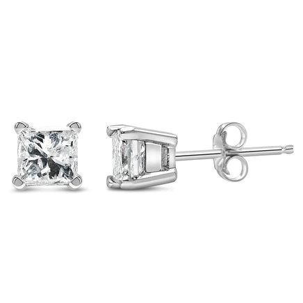 Size comparison of 14K white gold princess cut diamond stud earrings against a ruler, showcasing their compact and elegant design.