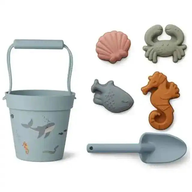 Ocean-themed beach toy set with a blue bucket decorated with sea creatures, a matching shovel, and marine animal sand molds for seaside adventures.