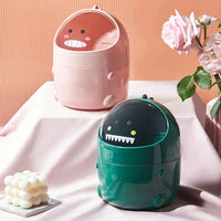 Set of pink and green dinosaur desktop trash cans on display, offering a fun and lightweight solution for tidy home office spaces.