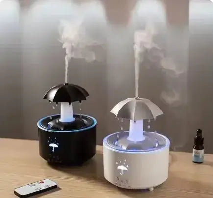 White and black Raindrop Aromatherapy Humidifiers side by side, emitting mist with LED lighting and essential oil diffusion.