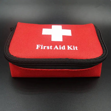 Red first aid kit bag with a white cross and zipper closure, designed for emergency preparedness and compact storage.