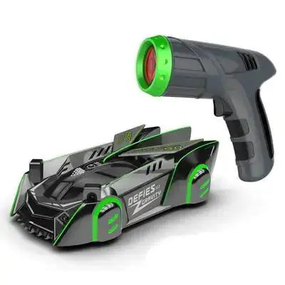 Green anti gravity car toy paired with a gray laser-guided remote control for wall and ceiling climbing.