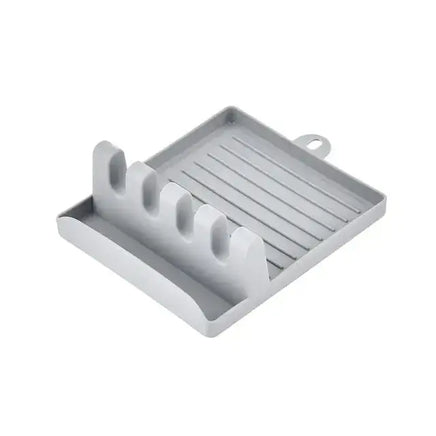 Gray spatula drain rack gadget with four slots and a drip tray, suitable for holding spatulas and other utensils.