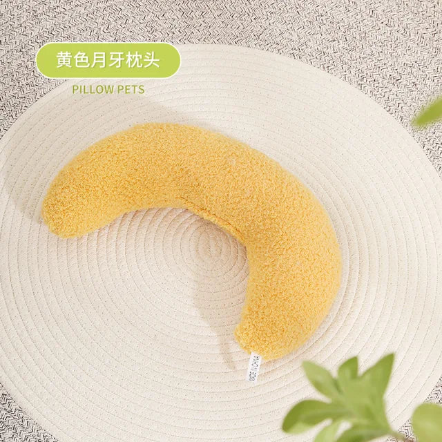 Yellow U-shaped pet pillow on beige surface
