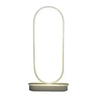 Modern oval LED table lamp with a sleek white base and glowing oval-shaped light, ideal for contemporary home or office decor.