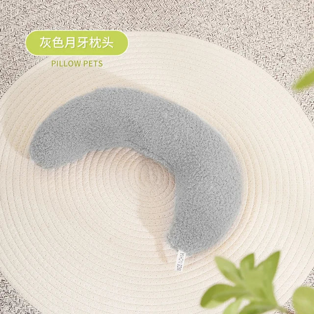 Gray U-shaped pet pillow on beige surface