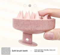 Close-up of pink soft rubber shampoo brush with flexible bristles, designed for gentle scalp care and comfortable grip.